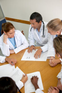 Medical staff conversing around a table