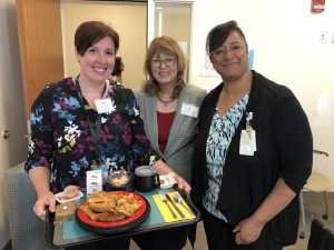 Dr. Busby-Whitehead with Nutrition and Food Services Dementia Champion Tracy Thorp and Clinical Nurse Education Specialist Krista Wells, featuring the "dementia-friendly food tray.'