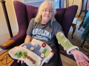 Cristine Henage shows off the dementia sleeves she has knitted