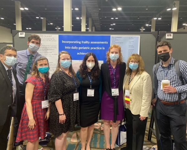 UNC Geriatrics clinicians, residents, and fellows in front of a poster at the 2022 AGS annual meeting. Dr. John Batsis, Dr. Max Hockenberry, Dr. Hillary Spangler, Dr. Brianna Harder, Dr. Tiffany Long, Dr. Sarah Stoneking, UNC Geriatrics Chief Dr. Jan Busby-Whitehead, and Dr. David Lynch.