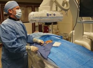 RA student participating in interventional radiology procedure