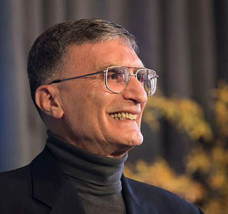 photo of face of Aziz Sancar at nobel event at David library April 2016 with yellow flowers in background