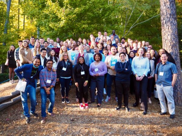 Large group of diverse employees standing together in the woods