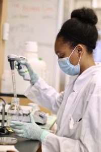  Najla Ward-Conyers undergraduate student in the lab with a pippette