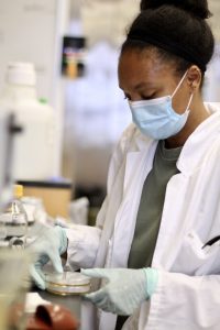  Najla Ward-Conyers undergraduate student in the lab with a petri dish