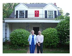 Gwen and Aziz Sancar standing in front of a white house called turk evi