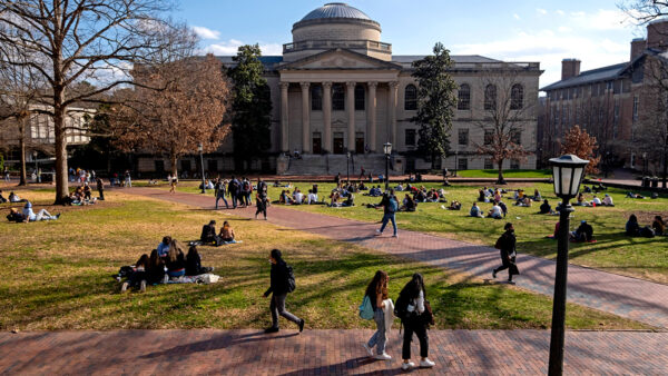 Students gather on Polk Place during a warm February afternoon on campus