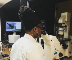 Martha S Johnson PhD by Microscope in a lab