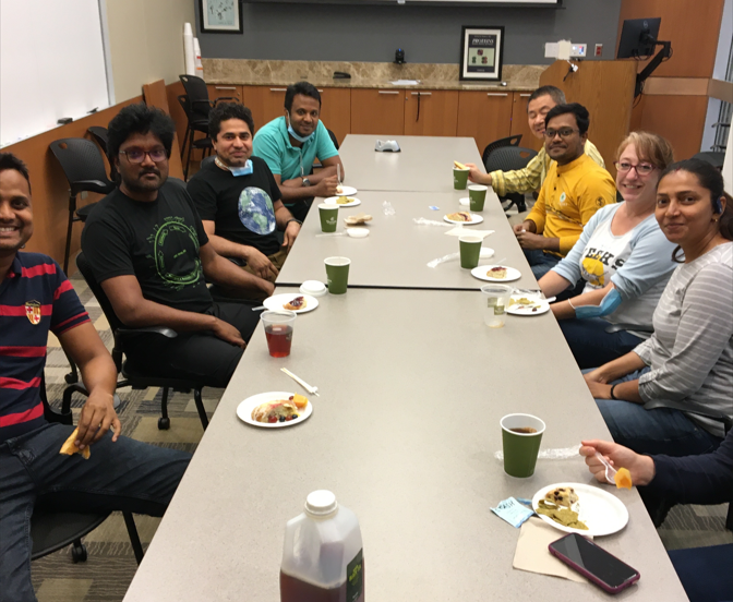 diverse postdocs sitting around a conference table on August 16 2022 for our first coffee hour