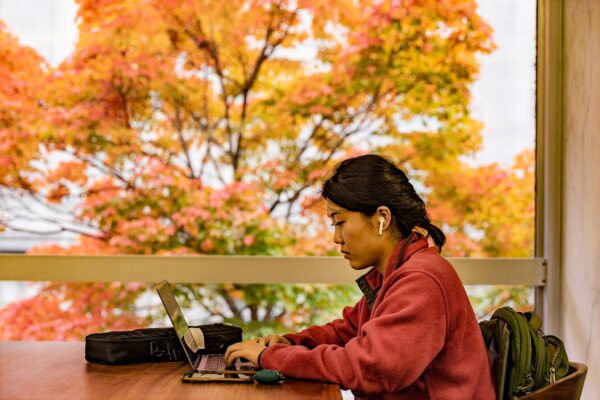 meditation image of Asian student at laptop computer
