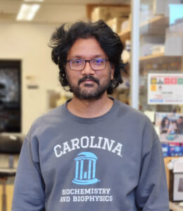 Venkata R Chirasani wearing a Carolina shirt in a lab
