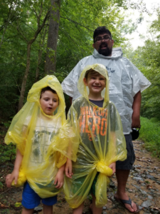 man with two children in yellow rain coats