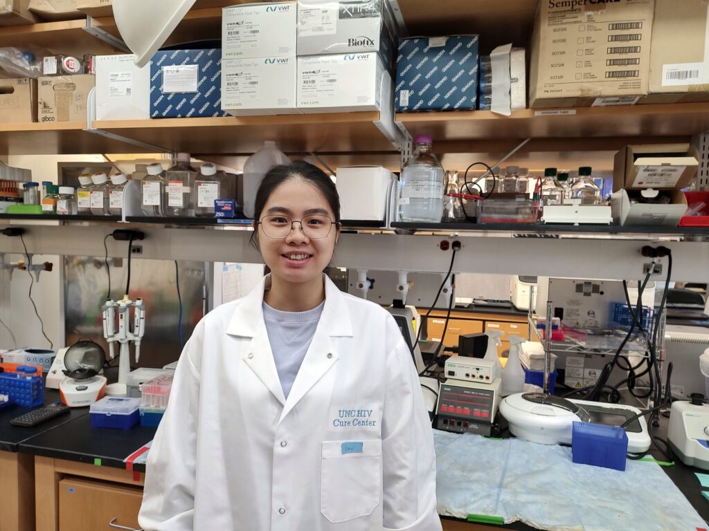 Xiaoyi Li in lab coat in Jiang research lab