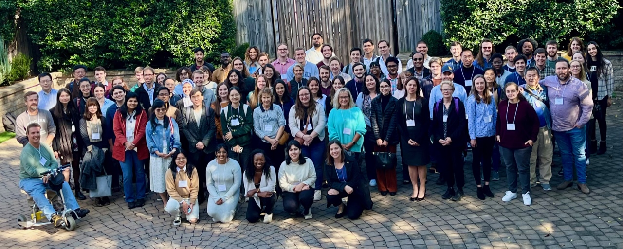 large group of diverse people standing outside for the biochemistry and biophysics group photo at the retreat in October 2023