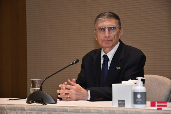 Aziz Sancar sitting at a table during a news conference.