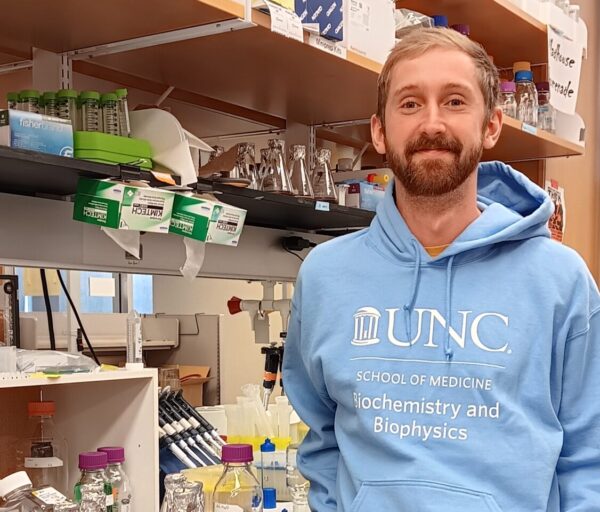 Dillon Sloan in blue sweatshirt in lab
