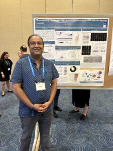 Kanishk Jain at a conference standing by his research poster