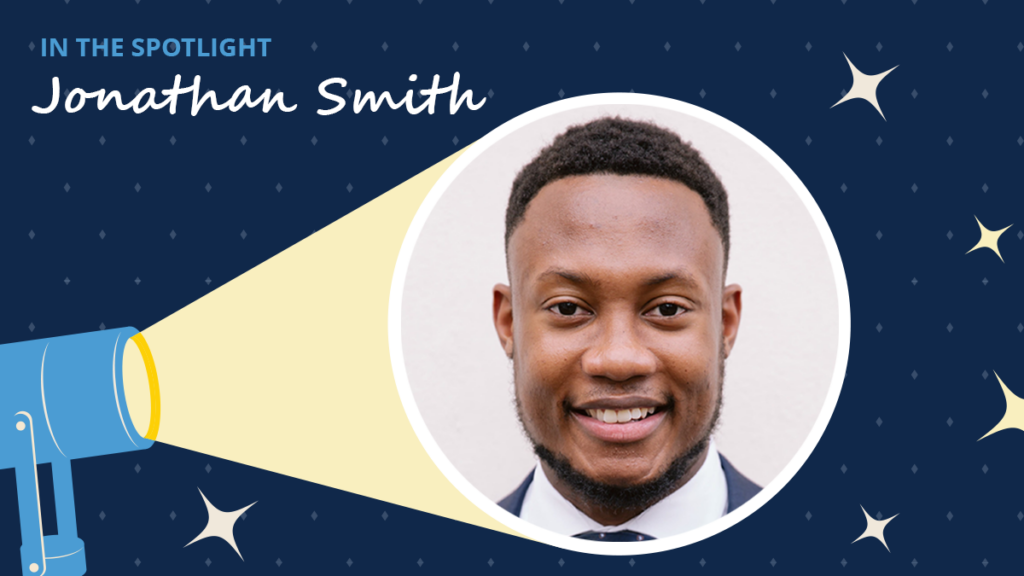Navy blue background has diamonds and starbursts. A spotlight icon shines on a circular image of Jonathan Smith. A label reads "In the spotlight." Below the label is the text "Jonathan Smith."