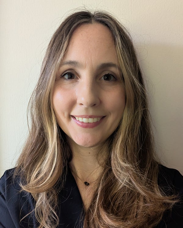 Photo of Lauren Kucirka, a smiling woman in a black dress shirt