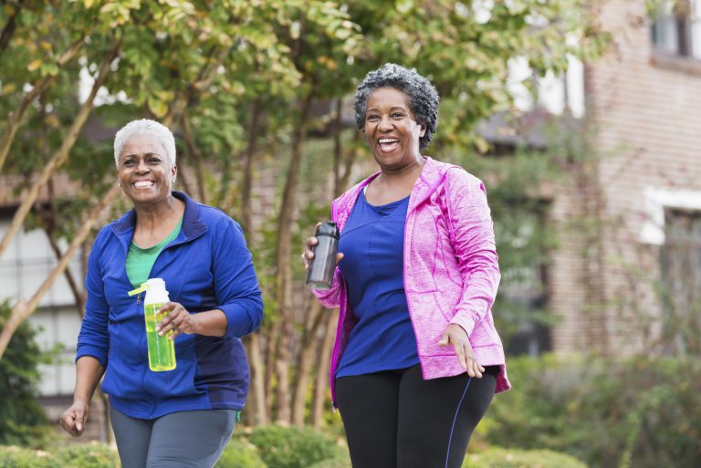 Two senior black women walking for exercise