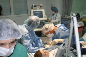 Surgical team performs surgery in an operating room (NEJM 2010)