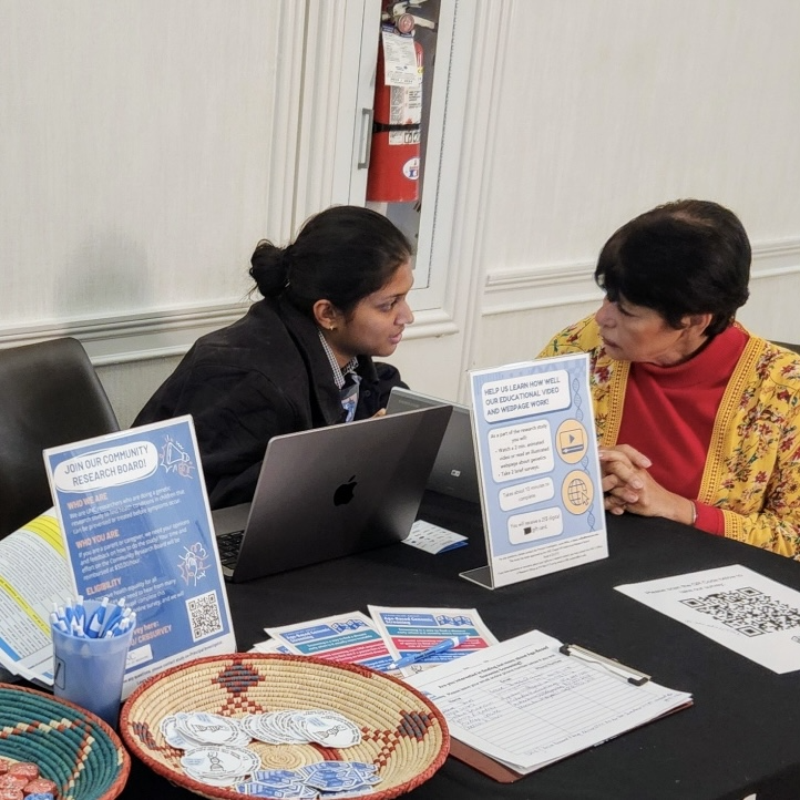 ABGS Team member talking to a woman at the table 