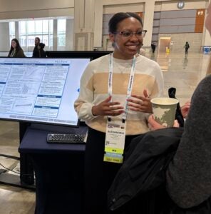 Alexandria Swaine presents a research poster.