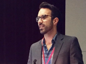 Dr. Ryan Lavalley speaking at podium