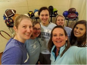 L to R, clockwise: Stacy Harris (Physical Therapy), faculty member Sonda Oppewal (Nursing), Erica Hennes (College of Arts and Sciences), Candace Beddard (Nursing), Olivia DeSena (Physical Therapy), and Tyrrell Elementary school PE teacher Terry Donoghue with equipment donated by UNC students
