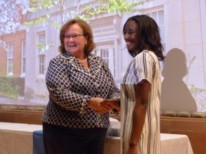 Dr. Debby Givens welcomes a student in the class of 2020 during a professionalism ceremony.