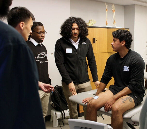 Group of students in the PT lab learning about DPT program on DPT Exploratory Day 2025.