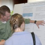 Kevin Cunningham explains his poster at the Speech and Hearing Sciences Student Research Day.