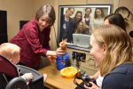Dr. Pat Roush plays with Cora Poindexter during a training lab for first-year audiology students held on April 13, 2018.