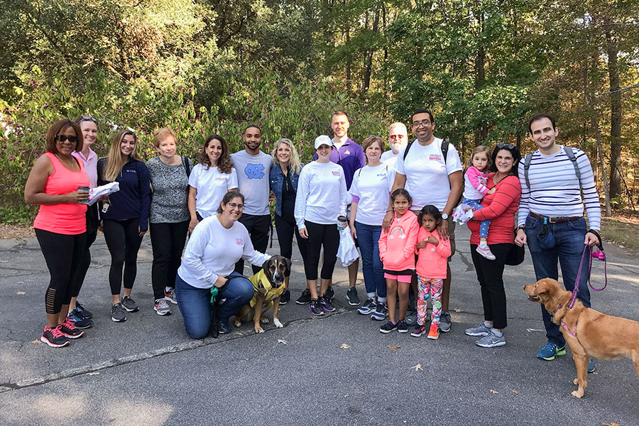 Group photo of HTC staff, families, and pups at 2019 HNC Raleigh walk.