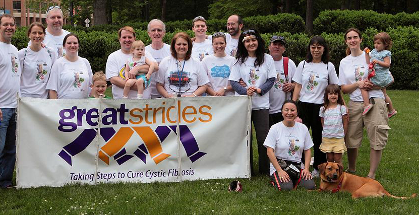 Silvia (front, kneeling) walking with her certified therapy dog, Whiskey, and CF Center colleagues during the annual Chapel Hill Great Strides walk to raise awareness and funds for Cystic Fibrosis research.