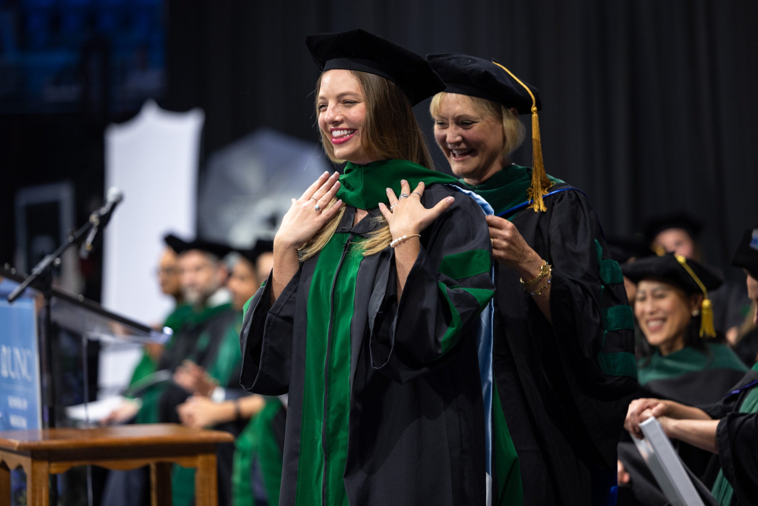 Student being hooded during 2025 graduation