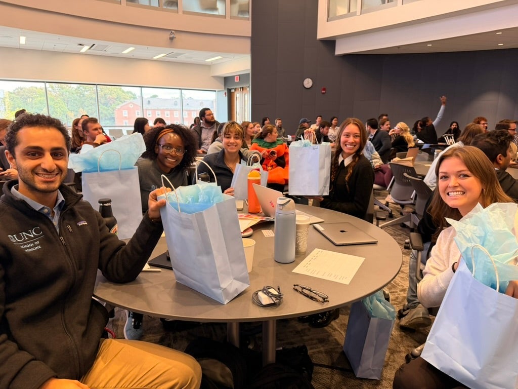 Winners from Step 1 review week hold their UNC SOM swag.