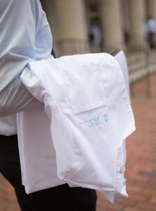 Medical student carrying White Coat