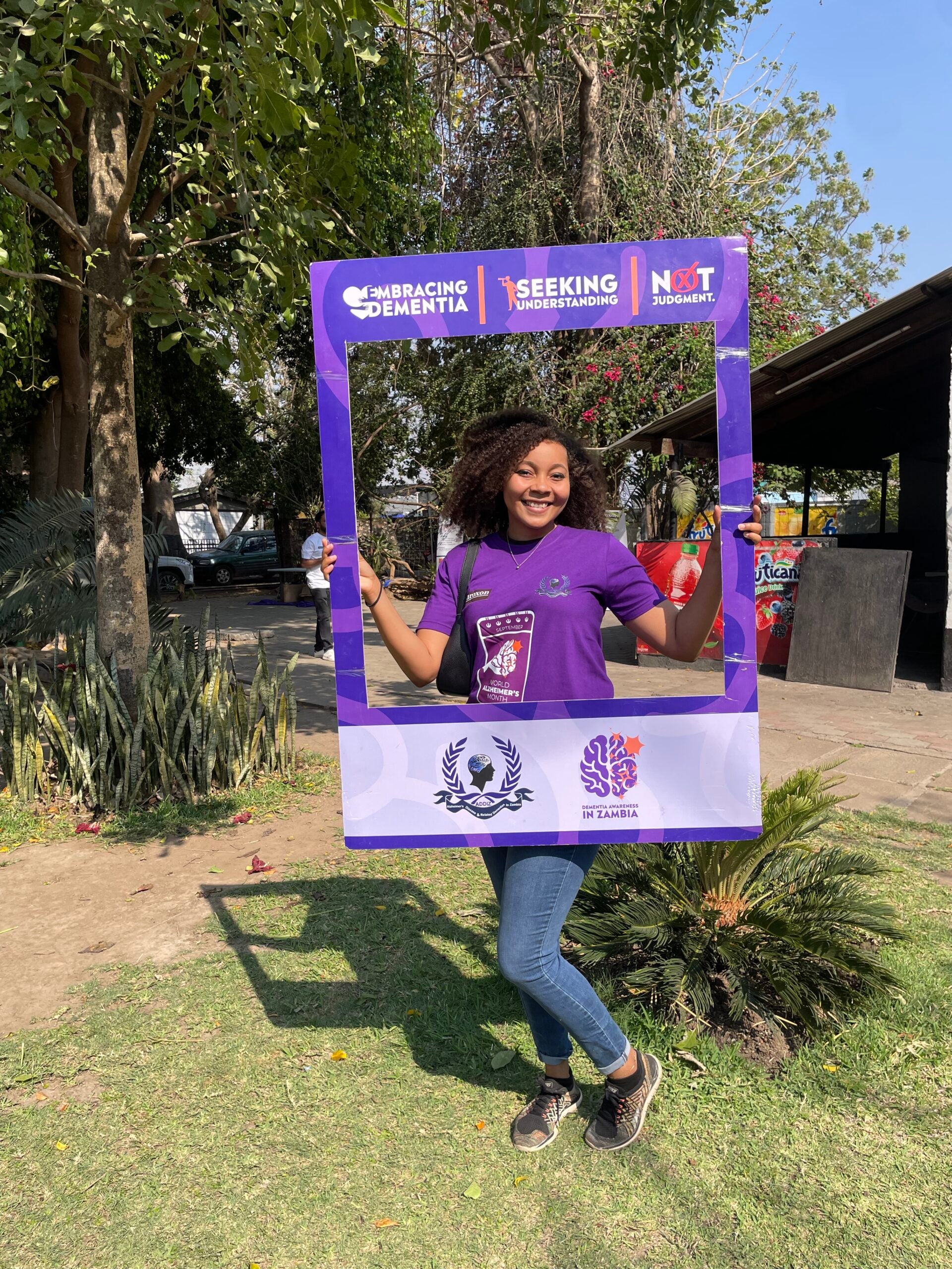 Nzia Hall holding a sign for dementia awareness