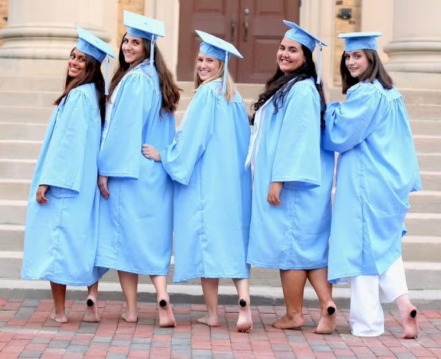 Five students taking UNC graduation photos. Katherine Poulos is second from the left.