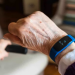 a Fitbit on the wrist of an elderly person