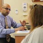 Dr. Sriram Machineni talks with a patient about her progress at the UNC Hospitals Diabetes and Endocrinology Clinic at Meadowmont.