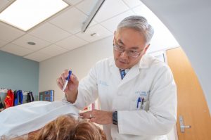 Dr. Huang examining a patient