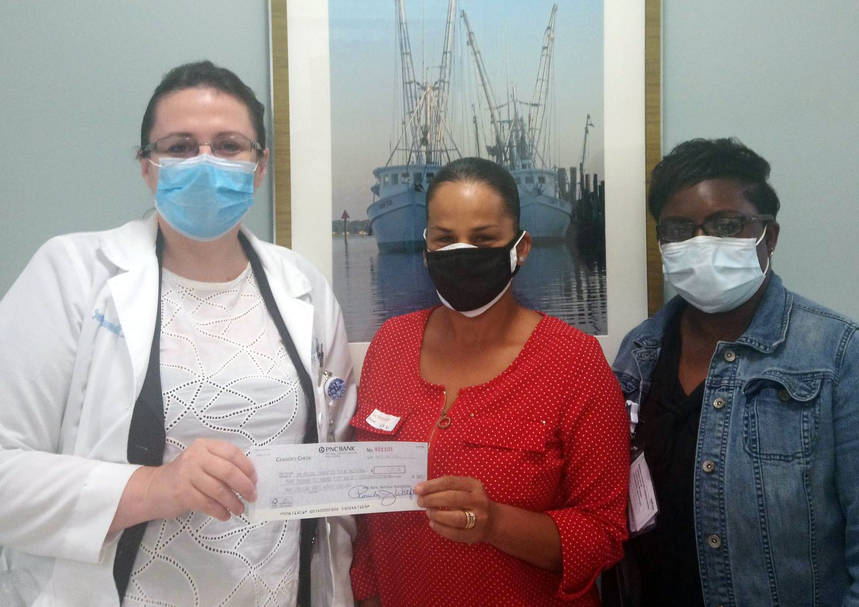 MS team holding a check donated by Mary Locklear and her family