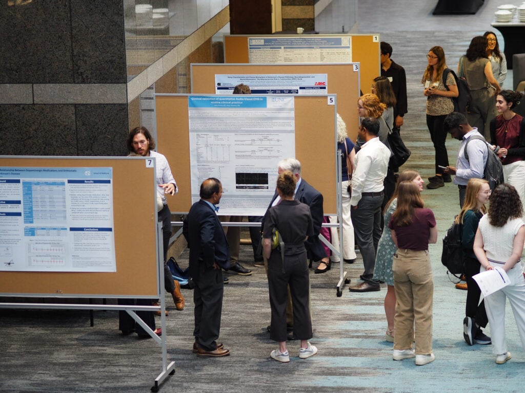 Attendees review research posters and discuss findings during a busy poster session at Neurology Day 2026.