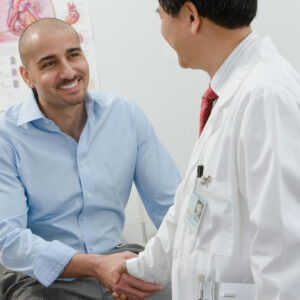 A medical provider shakes hands with a patient