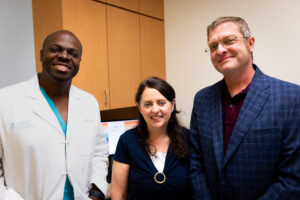 Sam, Brain Tumor Patient at UNC Health with his wife and Dr. Dominique Higgins