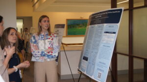 People overlook a poster about Fetal DNA at Research Resident Day 2024