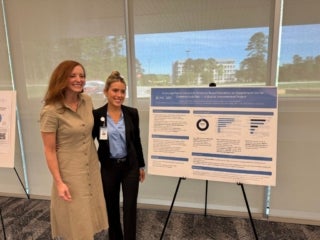UNC Medical Student, Megan Little pictured with her research. She is pictured with UNC MIGS Division Director, Dr. Erin Carey who is a contributor on the research.