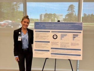 Megan Little, UNC Medical Student pictured with her research poster